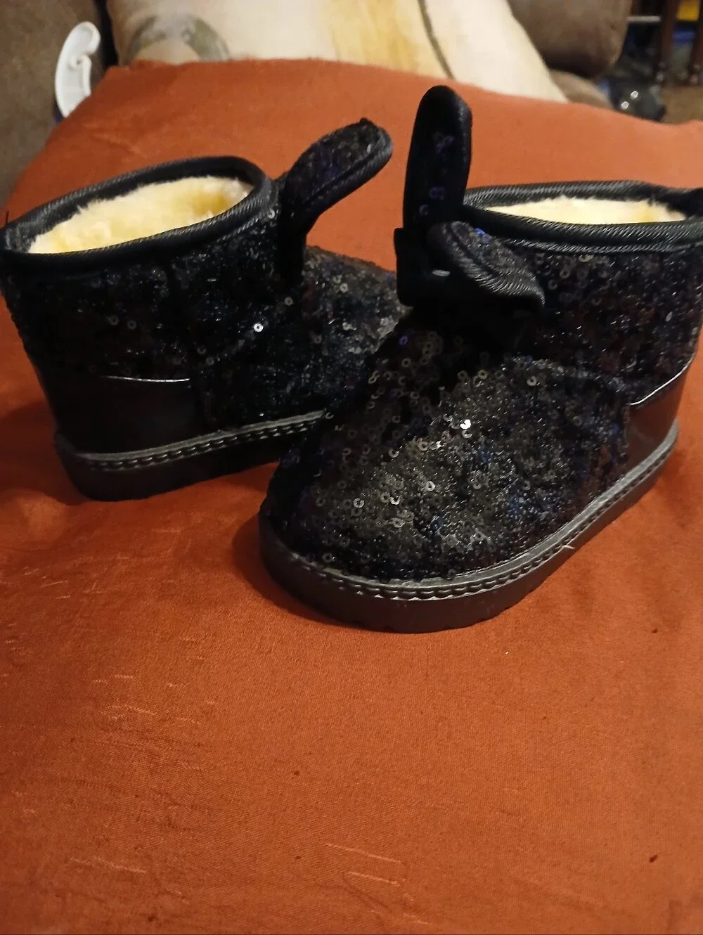 black sequin children's ankle boots with decorative bows and flat fur sole